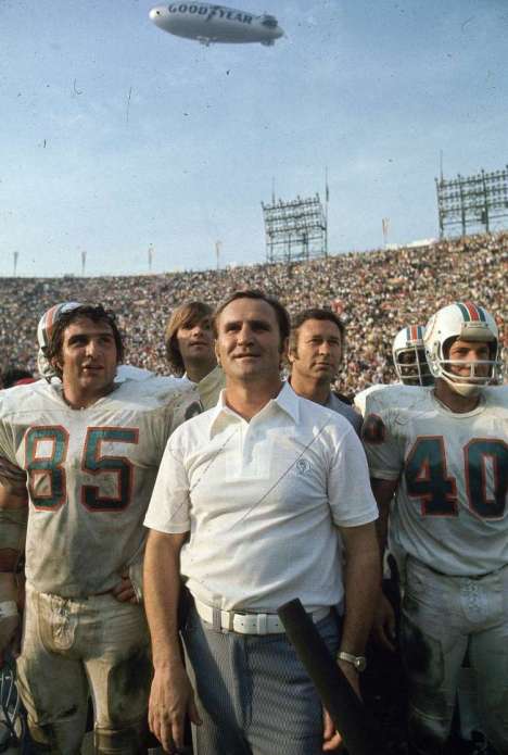 Miami Dolphins coach (C) with players after game vs Washington Redskins. . Dolphins go undefeated with 17 straight victories.